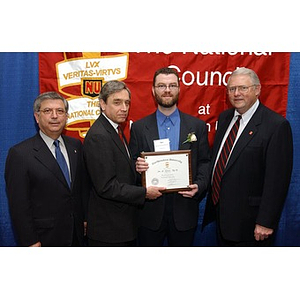 Unidentified inductee poses with his certificate and three others at the National Council Dinner