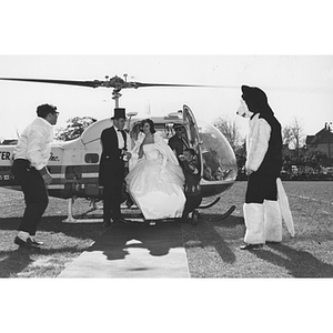 Northeastern's Homecoming Queen and the Mayor of Huntington Avenue exit a helicopter onto Kent Field