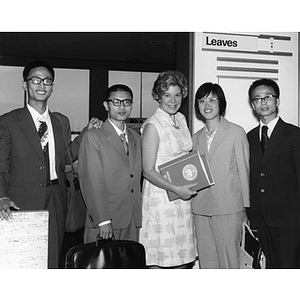 At Logan Airport, Joy Viola, Coordinator of International Affairs, assists the first four Chinese students at NU from Beijing Polytechnic University