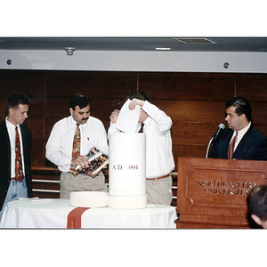 Items being placed in a time capsule at the Ell Center dedication