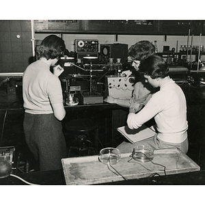 Female students perform experiments in a physiology laboratory