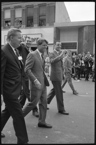 Robert F. Kennedy and entourage walking past the Youthtown store, Worthington, during the Turkey Day festivities