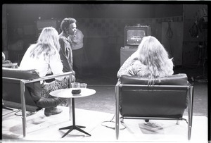 Commune members at the WGBY Catch 44 (public access television) interview: shot from the rear of Anne and Jim Baker on stage, looking at monitor