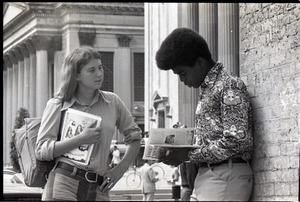 Irene White distributing Free Spirit Press magazine to young African American man in front of Springfield City Hall