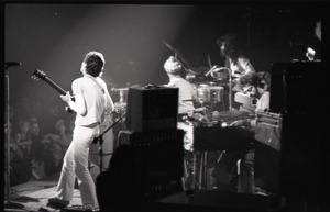 Santana concert at the Springfield Civic Center: Carlos Santana (guitar, back to camera) and band in performance