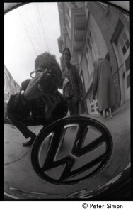 Peter Simon photographing his reflection (with Verandah Porche) in the hubcap of a Volkswagen Beetle
