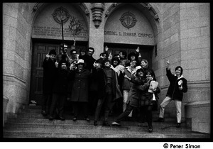 Boston University News staff in doorway of Marsh Chapel, flipping the bird: Peter Simon (ctr.) with Ed Siegel (far right), Sue Katz (2d from right), Clif Garboden and Stephen Davis (right, above Simon), and others