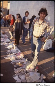 MUSE concert and rally: man stepping off curb onto pile of litter