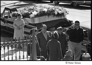 Jack Kerouac's funeral: men and women standing by hearse