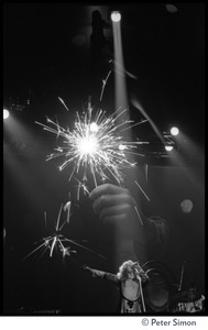 Robert Plant (vocals), on stage, with fireworks superimposed, in concert with Led Zeppelin at the Forum in Inglewood