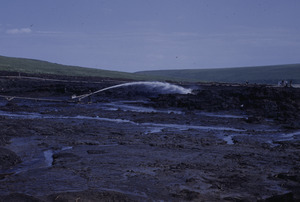 Water blasting cover of tundra so dredge can work