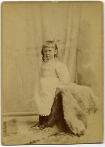 Alice Channing: full length studio portrait at three years old, with fur rug