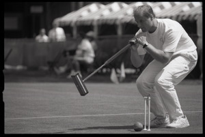 Croquet player following through on a shot, Newport, R.I.