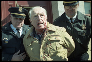 Elderly man with bloodied head (Wilfrid Lapierre) being arrested and removed from Chamber of Commerce building by two policemen after protesting the banking crisis