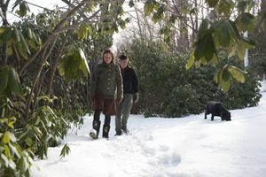 Couple and their dog walking through the snow at Naulakha, Rudyard Kipling's home from 1893-1896