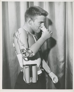 William Anderson uses his prosthetic arm to drink from a cup