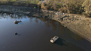 Aerial photograph of three vehicles revealed on lake bed of Lake Massasoit