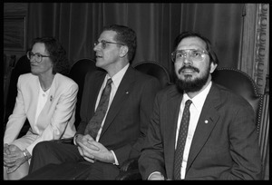 Russell A. Hulse (right) and Joseph H. Taylor seated with unidentified woman at a reception with Massachusetts state legislators honoring their Nobel Prize in Physics