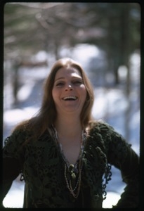 Judy Collins: half-length portrait in a green sweater, laughing