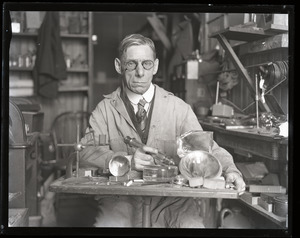 Walter G. Wolfe, industrial lens maker, at his work bench