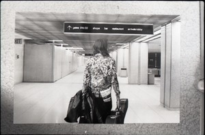 Young woman with a guitar case walking through an airport, a copy of Free Spirit Press (vol. 1, 4) in her back pocket: manipulated copy print inserting background of airport
