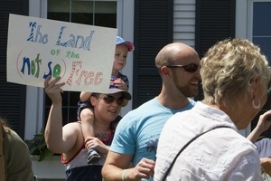 Pro-immigration protesters and signs outside the Chatham town offices building, one with a sign reading 'The land of the (not so) free' : taken at the 'Families Belong Together' protest against the Trump administration's immigration policies