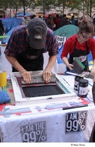 Occupy Wall Street: two demonstrators making silk-screened t-shirts