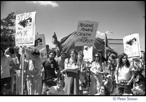 Protesters at a Mobilization for Survival antinuclear demonstration near Draper Laboratory, MIT, carrying signs opposing the MX missile and nuclear power