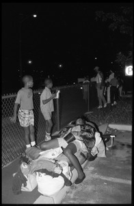 Woman sleeping on a makeshift bed as two boys look on, 25th Anniversary of the March on Washington