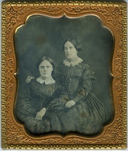 Emily and Hannah Cornelia Scott: double half-length studio portrait, seated, with arm around
