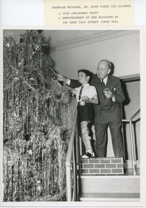 Jeremiah Milbank, Sr. decorating Christmas tree with young client