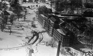 Aerial view of snowy fields and buildings