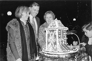 Mayor Raymond L. Flynn looking at gingerbread house