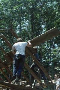 Positioning sheathing on the rafters at the Moon Barn Raising at entrance to Hopkins Forest on 2 August 1975.