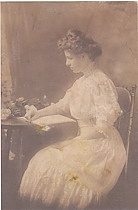 Seated woman at table with flowers