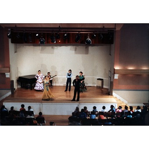 Dancers on stage at the Jorge Hernandez Cultural Center face the audience.