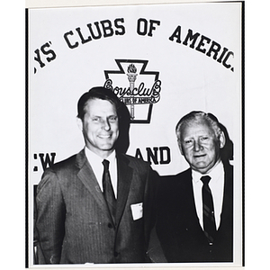 Richard Harte, Jr., at left, posing with an unidentified man in front of a Boys' Clubs of America banner