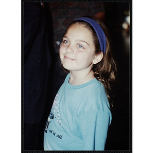 A smiling girl wearing a headband at a Boys and Girls Club Awards Night