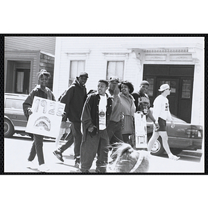 A group of boys and girls walking with parade signs during the Boys and Girls Clubs of Boston 100th Anniversary Celebration Parade