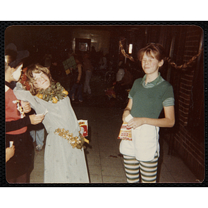 Girls in Halloween costumes enjoy snacks at a party