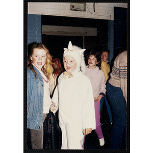 Girls in Halloween costumes attend a Halloween party