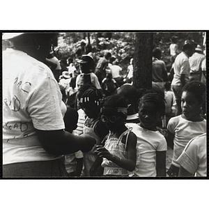 A Camp counselor handing out something to a group of children