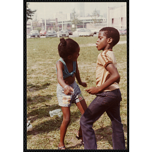 A boy and a girl dance on a field at the Tri-Club Field Day at the Roxbury Clubhouse
