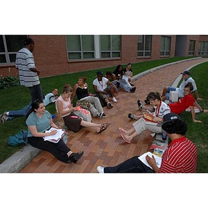 Students sit along a brick path during the Torch Scholars Scavenger Hunt