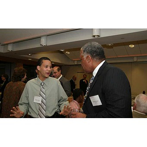 Odalis David Polanco and a man converse at the Torch Scholars dinner