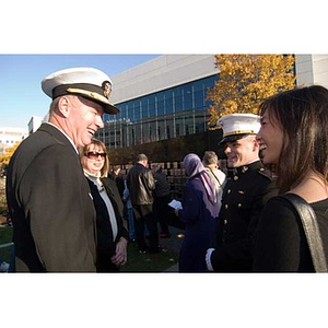 Vice Admiral Mark Fitzgerald converses with three people at the Veterans Memorial dedication ceremony