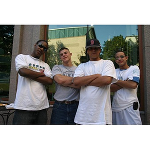 Four male Torch Scholars stand with arms crossed at the Question and Answer Pizza Party