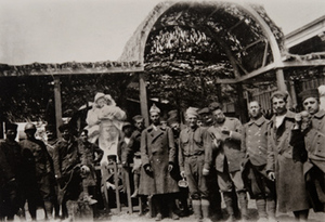 Group of soldiers pose for a photo in front of a canteen entrance