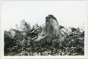 Ruins, with wall remaining among wreckage