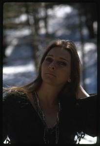 Judy Collins: half-length portrait in a green sweater, laughing